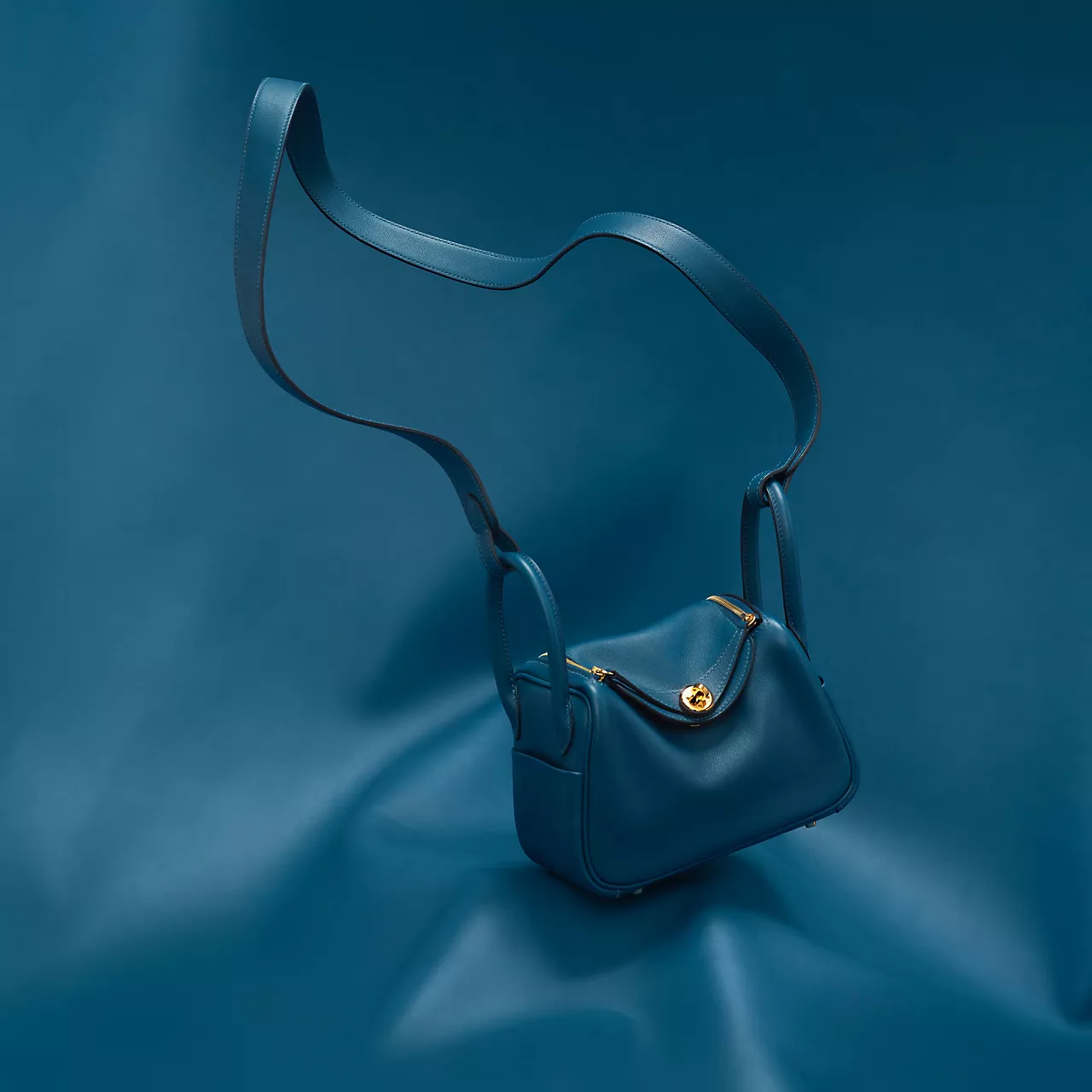 Lindy: Built For MovementNamed after the Lindy Hop, this one was designed for women who don't stand still. Its defining feature is a pair of side handles placed on the gussets rather than the top, a small design choice that lets the bag hug the hip rather than swing at it. The mini Lindy, in particular, has become a favourite for its compact frame and long, easy-to-sling strap. Expect a Lindy in India to start in the ₹4-5 lakh range depending on size and leather, making it comparatively more accessible within the Hermès universe. Lindy: Built For MovementNamed after the Lindy Hop, this one was designed for women who don't stand still. Its defining feature is a pair of side handles placed on the gussets rather than the top, a small design choice that lets the bag hug the hip rather than swing at it. The mini Lindy, in particular, has become a favourite for its compact frame and long, easy-to-sling strap. Expect a Lindy in India to start in the ₹4-5 lakh range depending on size and leather, making it comparatively more accessible within the Hermès universe.